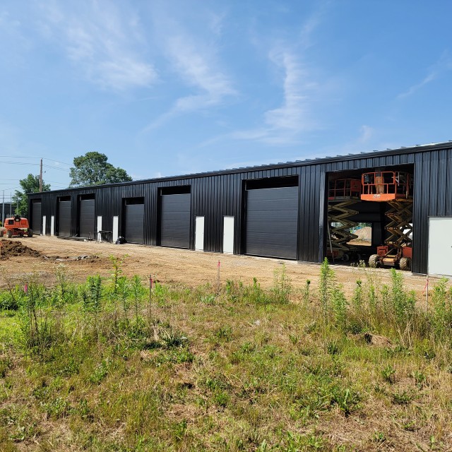 Commercial garage with multiple new black garage doors