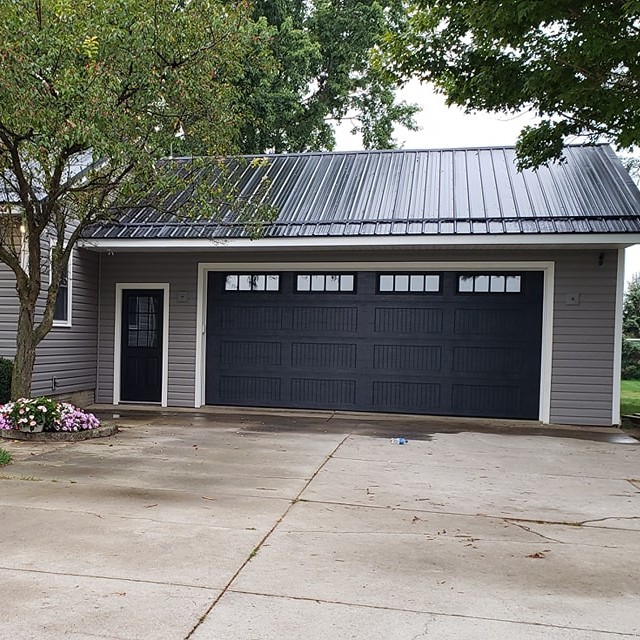 black garage door on a suburban house