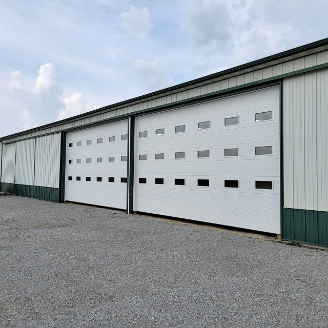 Two large garage doors on a warehouse building