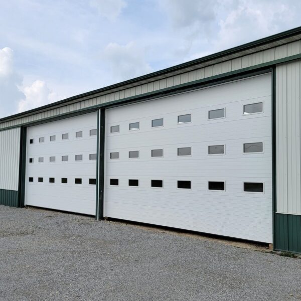 Two new large whhite Garage doors on a warehouse