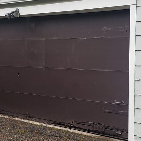 damaged brown garage door
